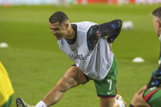 Football match, Cristiano RONALDO CR7 Portugal kneeling during pre-match warm-up with right leg and