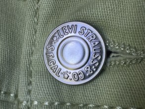 Calgary, Alberta, Canada. Jul 07, 2024. Close-up of a metal button branded with
