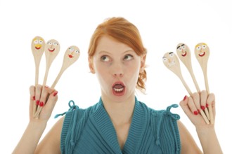 Woman cooking with funny wooden spoons