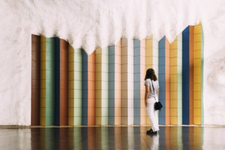 Stockholm, Sweden, August 9, 2019: Blurred motion woman looking at tile colorful pattern in