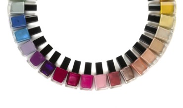 Bottles with nail polish arranged in a semicircle. Isolate on white background
