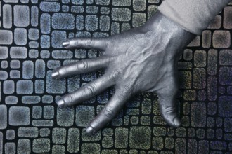 Male futuristic man silver hand over textured steel background