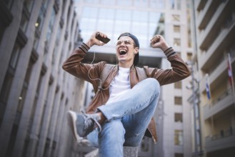 Man Sitting Listening Music Earphones Concept. Cheerful young guy listening the music