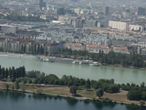 City view with buildings along a river and green trees, Vienna, Austria, Europe