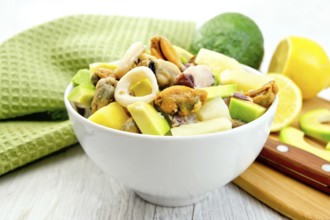 Salad with shrimp, octopus, mussels and calamari with avocado, lettuce, lemon and pineapple in a