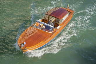 Wooden boat on the Grand Canal, possibly a Riva boat, Venice, Veneto, Italy, Europe
