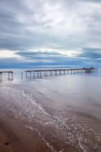 Ruined ocean pier in Punta Arenas. Strait of Magellan. South America. The famous Tierra del Fuego