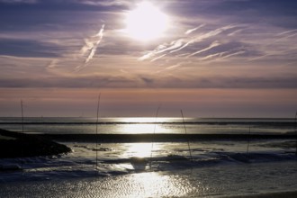 Atmospheric picture of moonlight on water with pastel-coloured sky and calm atmosphere,