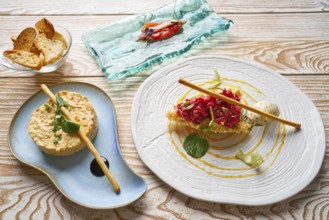 Food starters potato salad Steak tartare and Anchovies with tomato Tapas