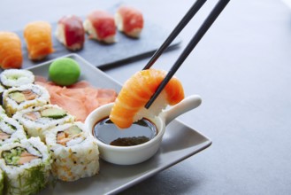 Sushi Maki and Niguiri with soy sauce and wasabi with California Roll