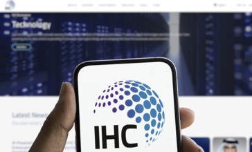 IHC logo is displayed on smartphone. International Holding Company (IHC) is a UAE based holding