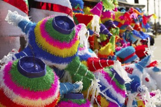 Mexican party pinatas decorated with fringed tissue colorful paper