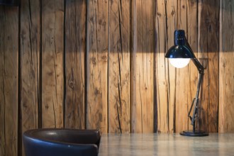 Vintage black desk lamp on wood background Vintage background with lighting retro desk lamp on wood
