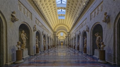 Grand museum corridor lined with marble statues and ornate arches, Chiaramonti museum, Rome, Lazio,