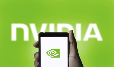 Nvidia logo on smartphone screen with AI in the background. Nvidia Corporation is an American