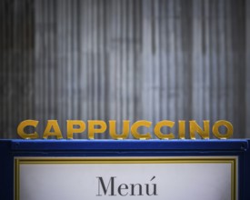 A Sign For Cappuccino At An Urban Coffee Shop With Copy Space