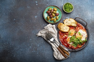 Middle Eastern and Maghrebi healthy dish Shakshouka made of eggs and tomato sauce served in pan