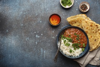 Traditional Indian Punjabi dish Dal makhani with lentils and beans in black bowl served with