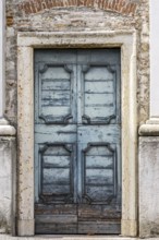 An old wooden blue door at a house in Italy