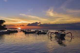 Sunset at Mushroom Beach with boats on the sea, Lembongan, Bali, Indonesia, Asia