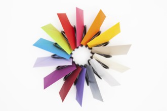 Propeller of colored envelopes on the white table