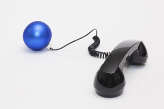 Old phone reciever and cord connection with Christmas decoration. Christmas hotline concept