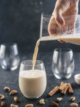 Thandai or Sardai cold drink made during Holi festival. Cold milk drink poured in glass, with