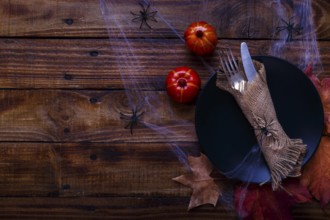 Halloween table setting on old rustic wooden table. Holiday card template
