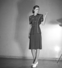 Fashion 1946, a young female model dressed in the fashion of the post war era. The dress with short