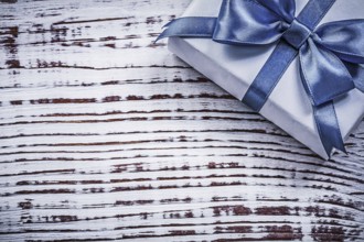 Packed present box on vintage wooden board holidays concept