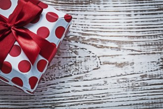 Gift box on vintage wooden board holidays concept