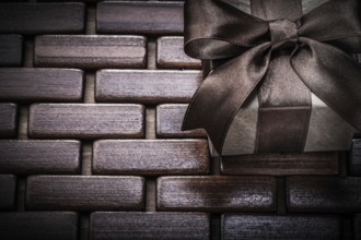 Gift box on wooden wicker place mat holidays concept
