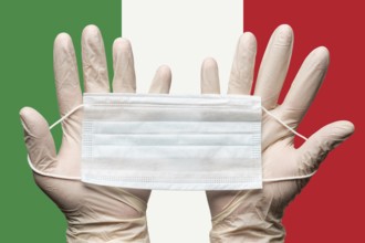 Paramedic holding respiratory face mask in two hands in white gloves on background flag of Italy.