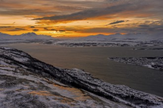 Winter view from Mount Storsteinen to the southern tip of Tromso at sunset, Troms, Norway, Europe
