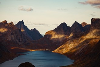 Mountain peaks casting shadows over a tranquil lake at sunset, mountains, rocks, road, sea, ocean,