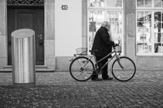 Old man with bicycle in zurich, switzerland