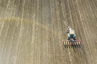 Farmer seeding crops at field. Seeding Aerial View