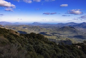 Wide view over mountainous landscape and the sea in the distance, Sardinia, Italy, Europe
