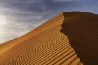 A view of the sand dunes at Erg Chebbi in Morocco in warm evening light