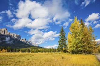 The Three Sisters mountains in Canadian Rockies. Shining autumn day in Canmore. Mountain peaks and