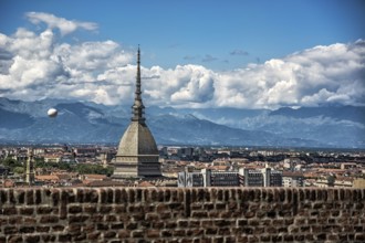 Panoramic view of Turin city center, in Italy, in a sunny day, with Mole Antonelliana and Alps in