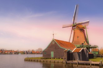Zaanse Schans, Netherlands pink sunset panoramic view of windmills and lake in traditional village