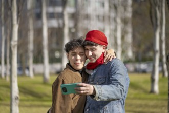 Young gay couple making funny faces taking selfies