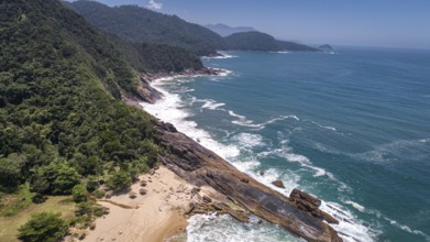 Aerial view to wonderful Green Coast shoreline with rock slabs, beach and mountains covered with