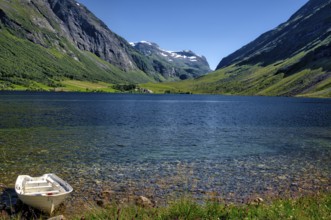 The landscape with a mountain lake near the Geirangerfjord in summertime in Norway is beautiful and