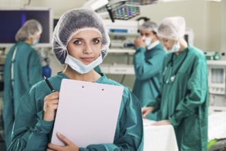 Portrait of surgeons in surgery with doctors working on background