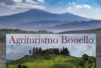 Agriturismo Bonello sign in a picturesque landscape with green meadows and mountains in the