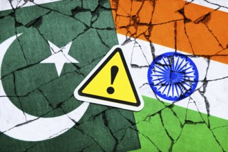 Danger sign with exclamation mark on the flags of Pakistan and India, symbolic photo Kashmir
