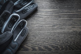 Pair of working gloves on wooden board