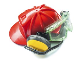 Construction tools red helmet yellow headphones and green goggles isolated on white background